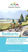 Das Bild zeigt das Titelbild der Radkarte der Zugspitz Region. Darauf zu sehen sind 2 Fahrradfahrer vor grünen Wiesen und sonnigem Alpenpanorama.